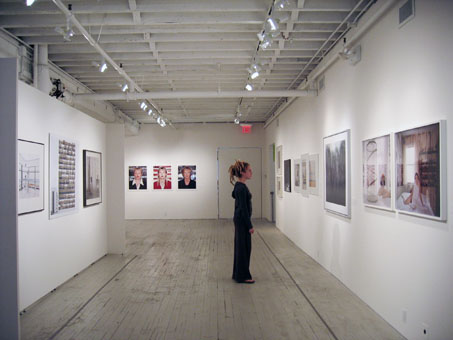 A guest views the exhibition reGeneration: 50 Photographers of Tomorrow on view at Aperture Gallery