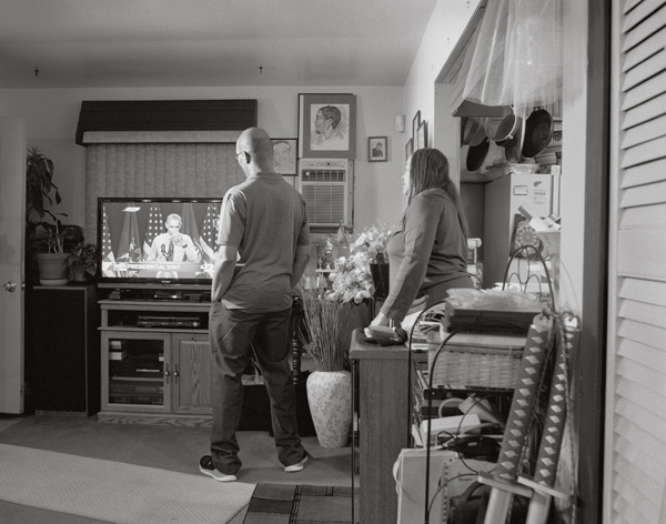 LaToya Ruby Frazier, Denise and Rodney Clay, Shea's aunt and uncle, watch President Obama take a sip of Flint water on television, 2016, from the series Flint is Family Courtesy the artist, Gavin Brown's Enterprise, New York/Rome, and Michel Rein, Paris/Brussels