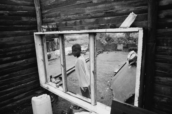 Andrew Tshabangu, Boy at the Window, from the series Emakhaya, 2004 Courtesy the artist and Gallery MOMO