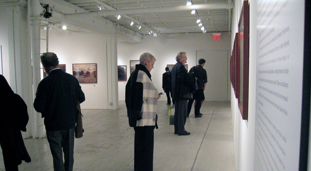 Guests view the exhibition Landscapes without Memory by Joan Fontcuberta and Parallel Memories by Bruno Rosier at Aperture Gallery