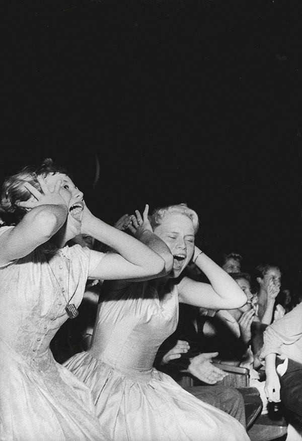 Teenagers screaming and yelling during singer Elvis Presley's personal appearance at the Florida Theatre.  (Photo by Robert W. Kelley/The LIFE Picture Collection/Getty Images)