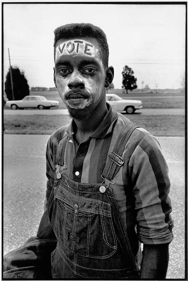 Bruce Davidson, USA. Alabama. 1965. Young man with "Vote" painted on his forehead walking in the Selma March, 1965 © Bruce Davidson/Magnum Photos