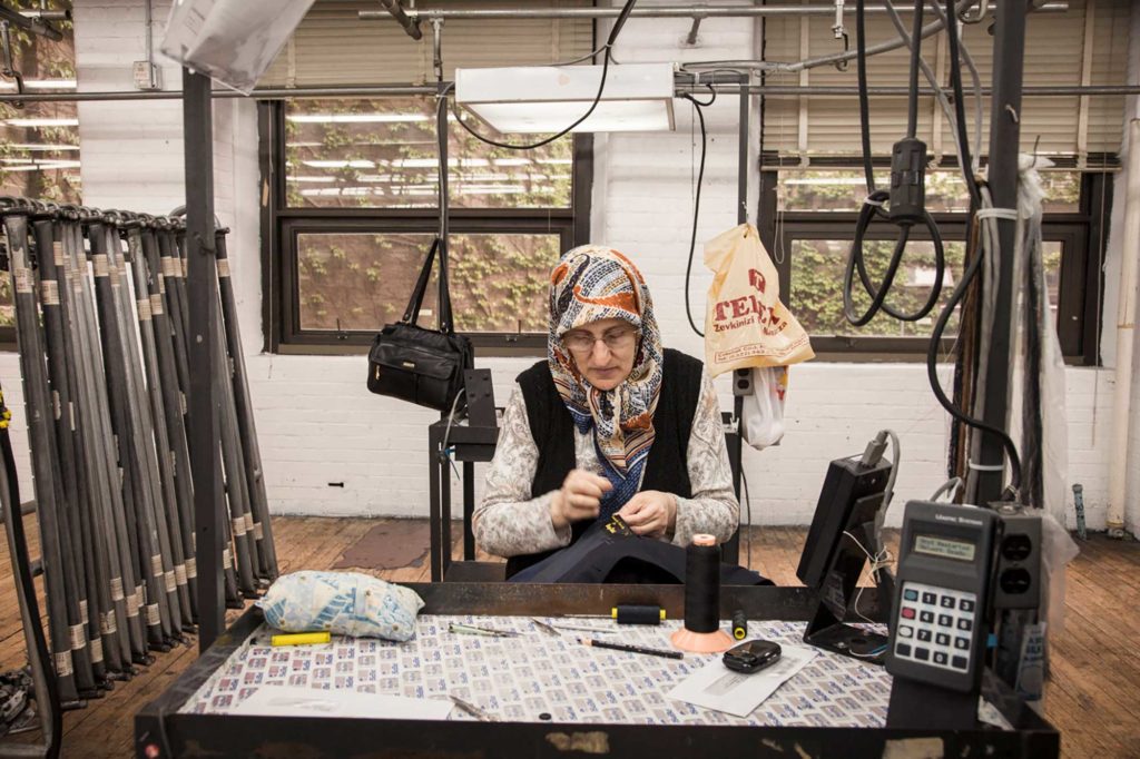 Susan Meiselas, Sultan from Turkey, stitching button holes, Hickey Freeman, Rochester, New York, 2012