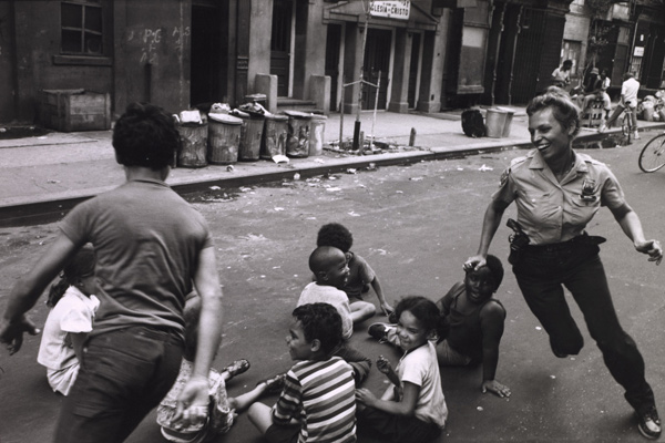 Leonard Freed, A policewoman plays games with community children. Shortly afterward, the officer became pregnant and was assigned a desk job for the period of her pregnancy, from Police Work, 1978 Courtesy Leonard Freed / Magnum Photos 