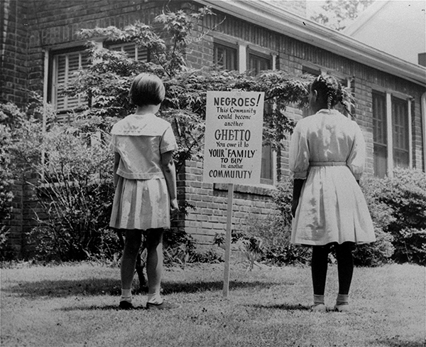 Photographer Unknown, An African American and a white girl study a sign in the integrated Long Island community of Lakeview, New York, on April 1962 Courtesy the Associated Press