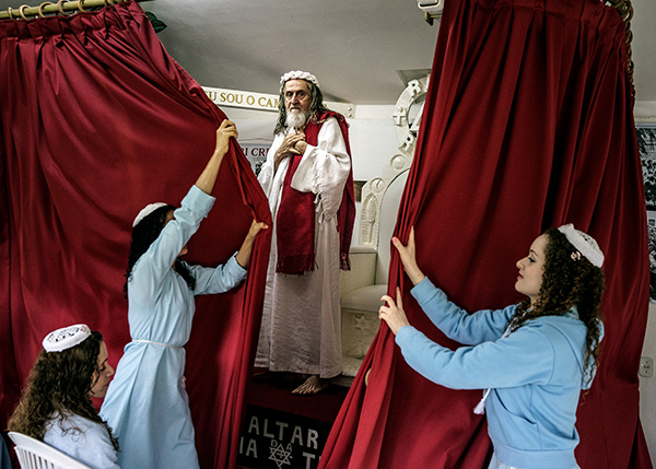 Jonas Bendiksen, Disciples shut the curtains in front of INRI Cristo after he has delivered the sermon of the day, Brazil, 2014 © the artist/Magnum Photos