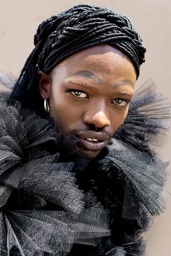 Jamal Nxedlana, FAKA Portrait, Johannesburg, 2019. Portrait of a person with a second set of eyebrows drawn on wearing tulle and hoop earrings.