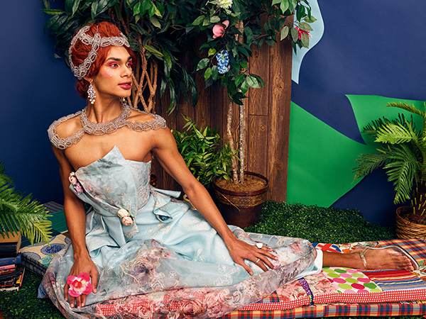 Zachary Tye Richardson wears a dress and sits on cushions. Mickalene Thomas, 2009.