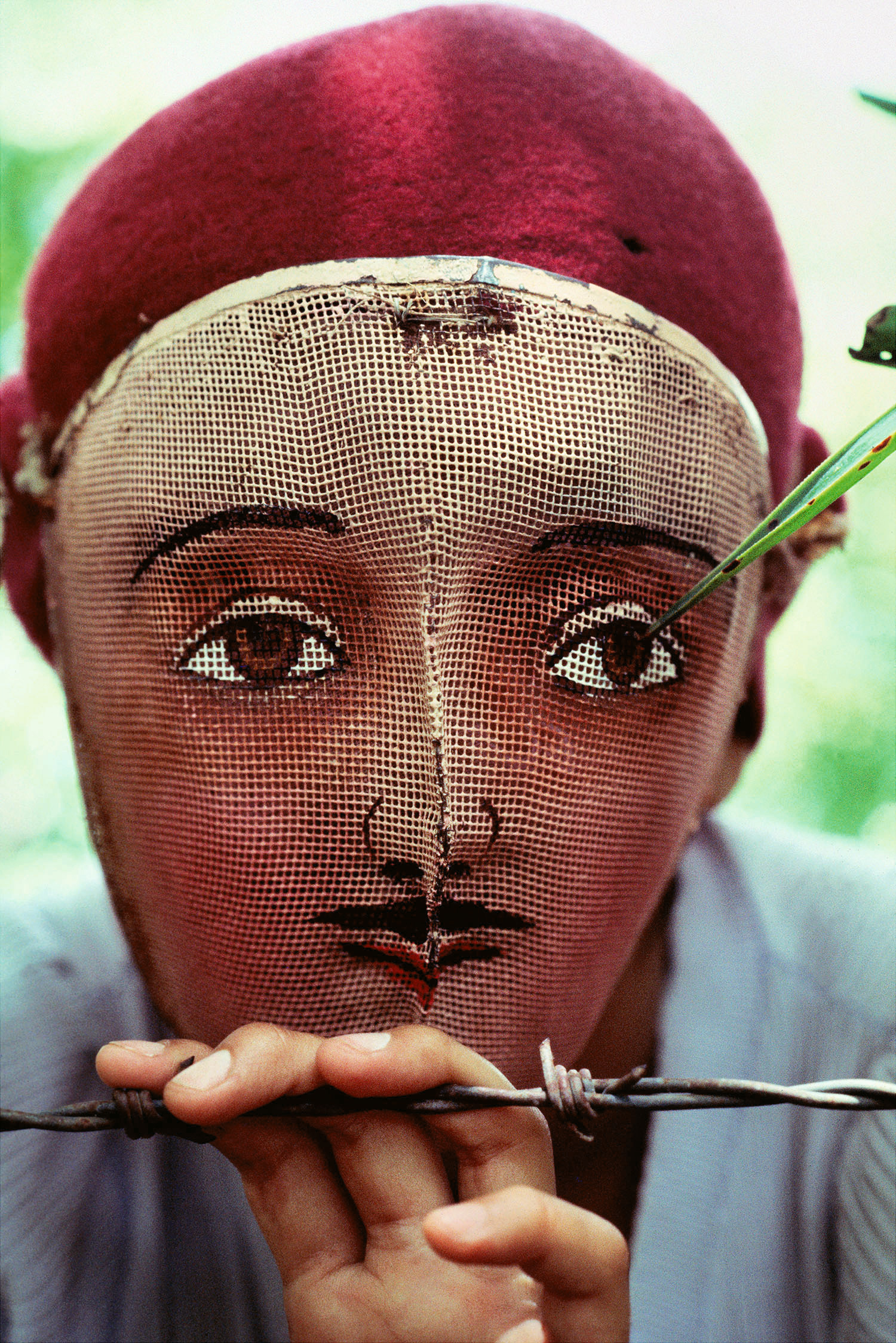 Susan Meiselas, color portrait of figure in mask