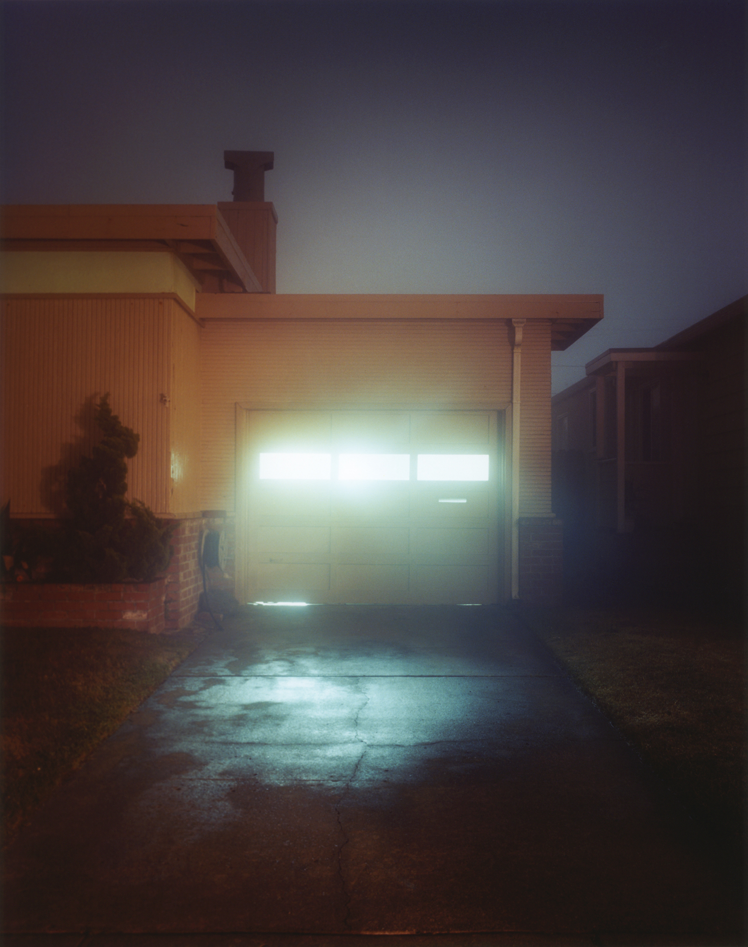 Todd Hido, color photograph of light coming out of garage windows