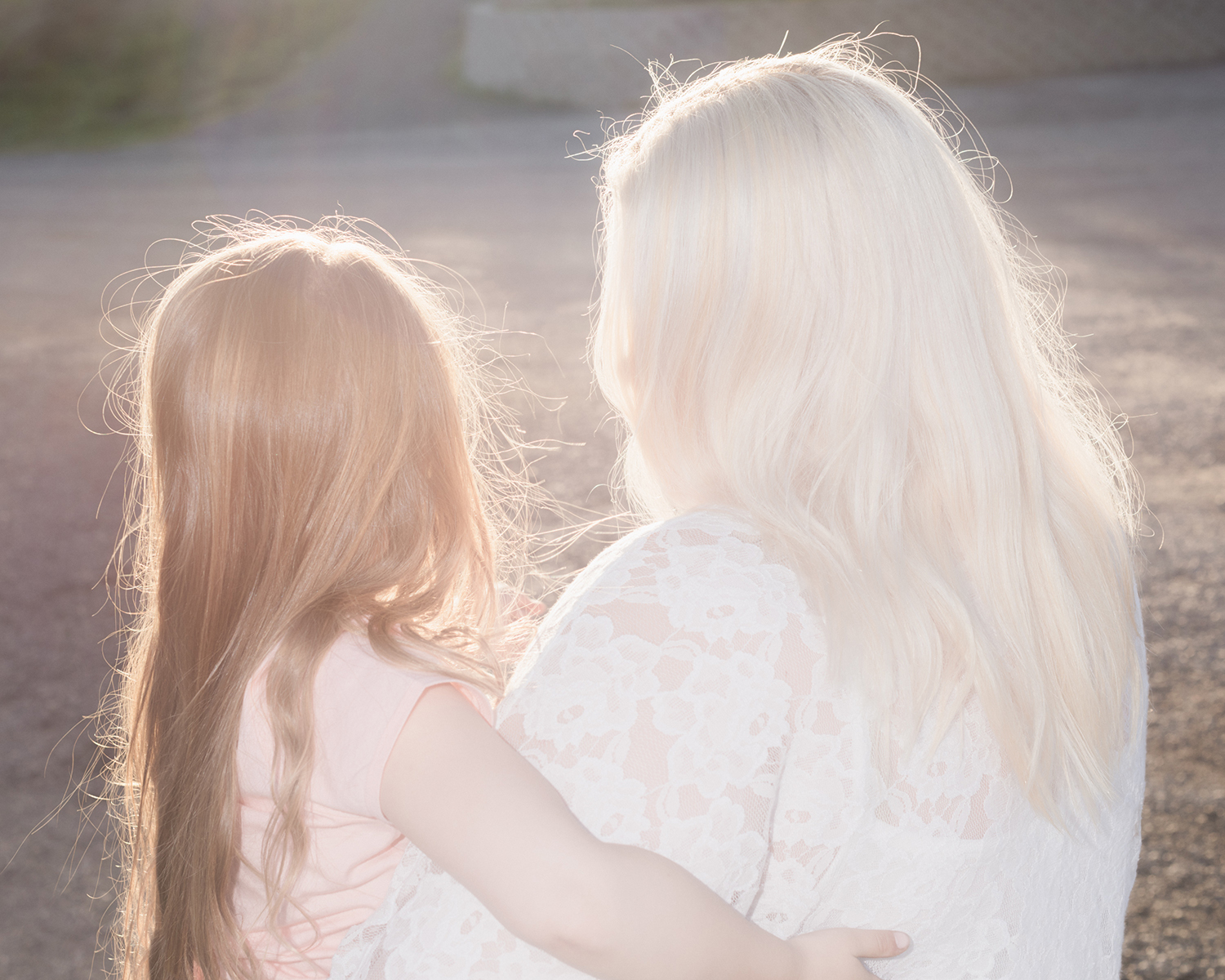 Color photograph of two people in sunlight