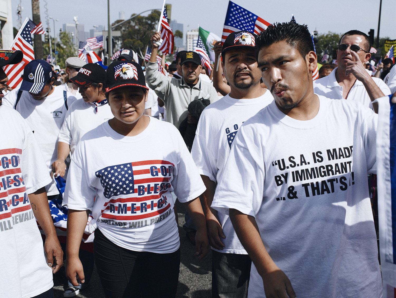 Protesters at an immigration march, american flags in background
