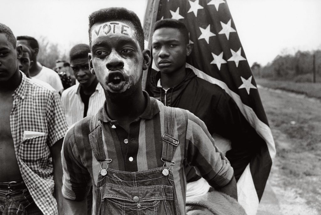 Bruce Davidson, A young African American man with the word "VOTE" on his forehead, Alabama, 1965