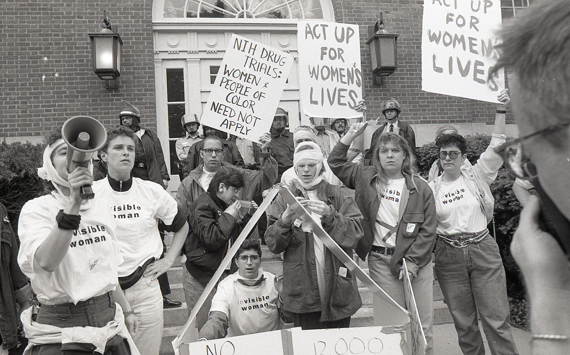Donna Binder, Women of ACT-UP demonstrate at NIH, 1990<br />© Donna Binder”>
		</div>
		<div class=