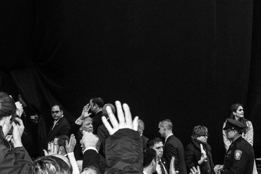 Peter van Agtmael, Donald Trump waves farewell to the crowd at a rally at Verizon Center on the eve of the New Hampshire primary, Manchester, NH, 2016