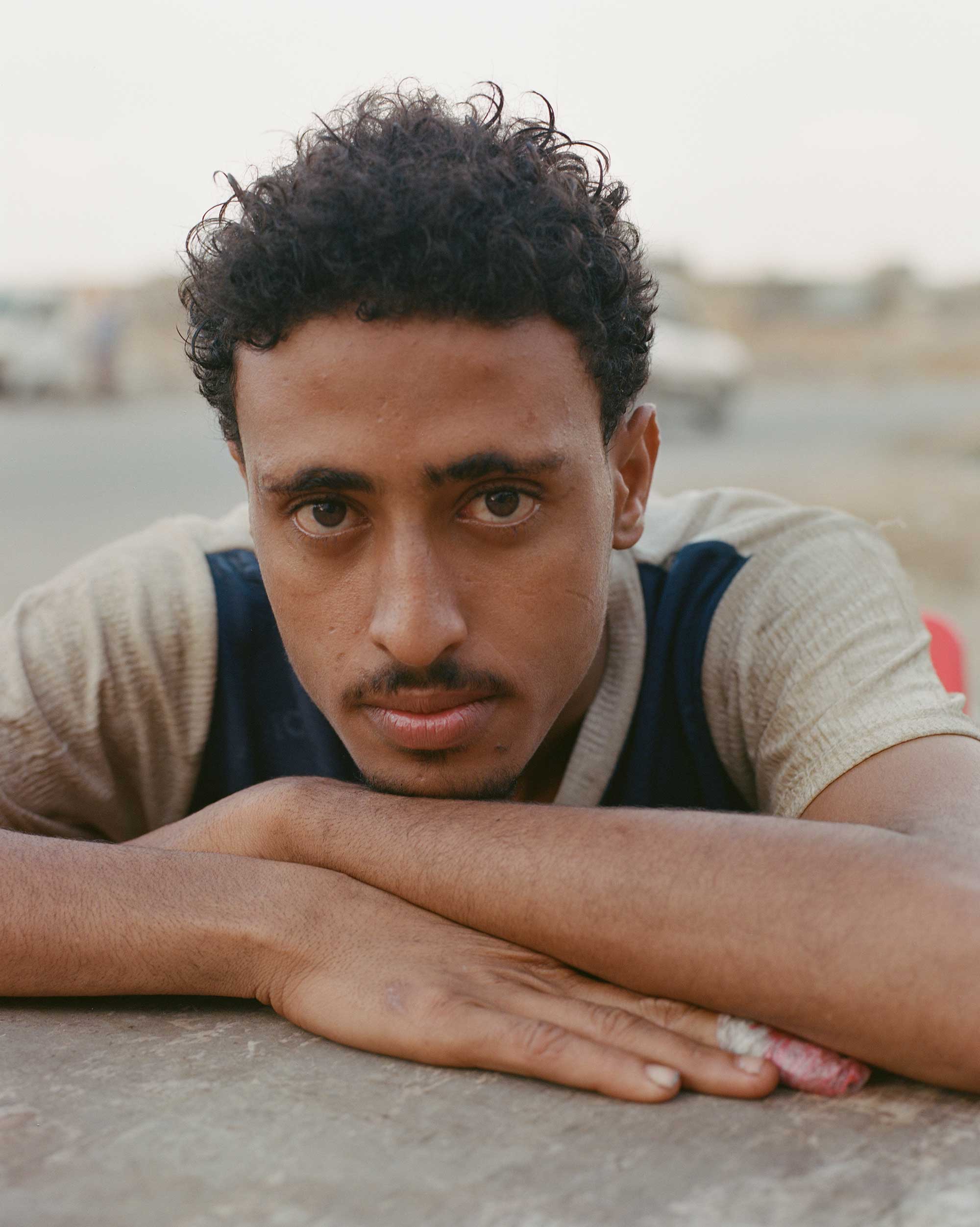 Charles Thiefaine, <em>Ibrahim, originally from Taez, a city in south Yemen where Yemeni troops and Houthi militias fought at the beginning of the civil war in 2015, came to Socotra in September 2021, and works in a restaurant with his friend Mohamed</em>, Socotra, 2021″>
		</div>
		<div class=