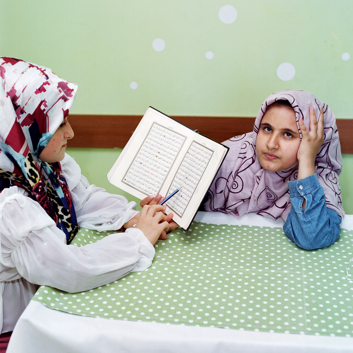 Sabiha Çimen, <em>Hatice, nine, tries to recite Quran passages from memory to her classmate</em>, Istanbul, 2021″>
		</div>
		<div class=