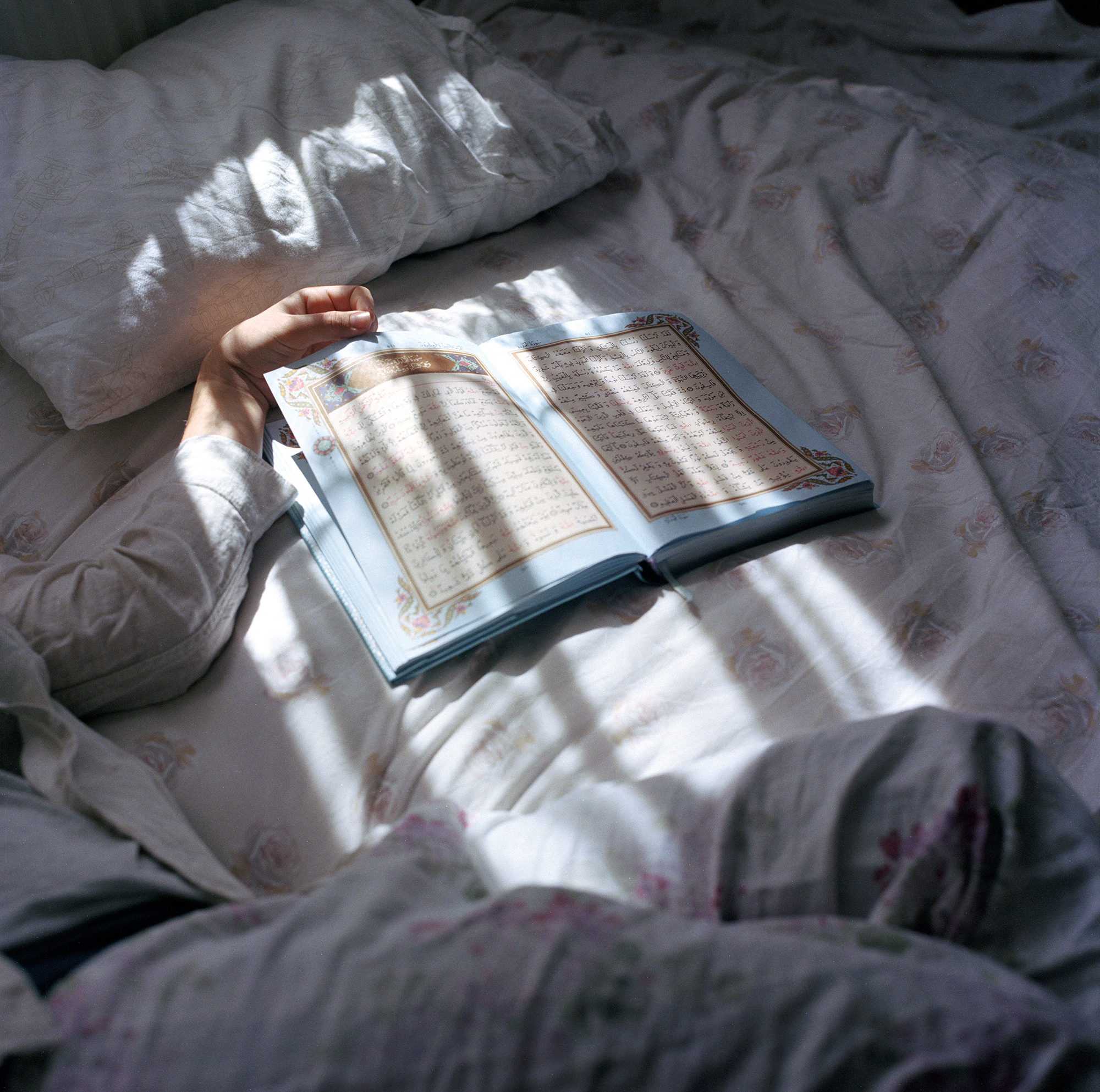 Sabiha Çimen, <em>Havva lies in the sickroom at a Quran school while listening to music with earbuds under her headscarf</em>, Istanbul, 2017″>
		</div>
		<div class=