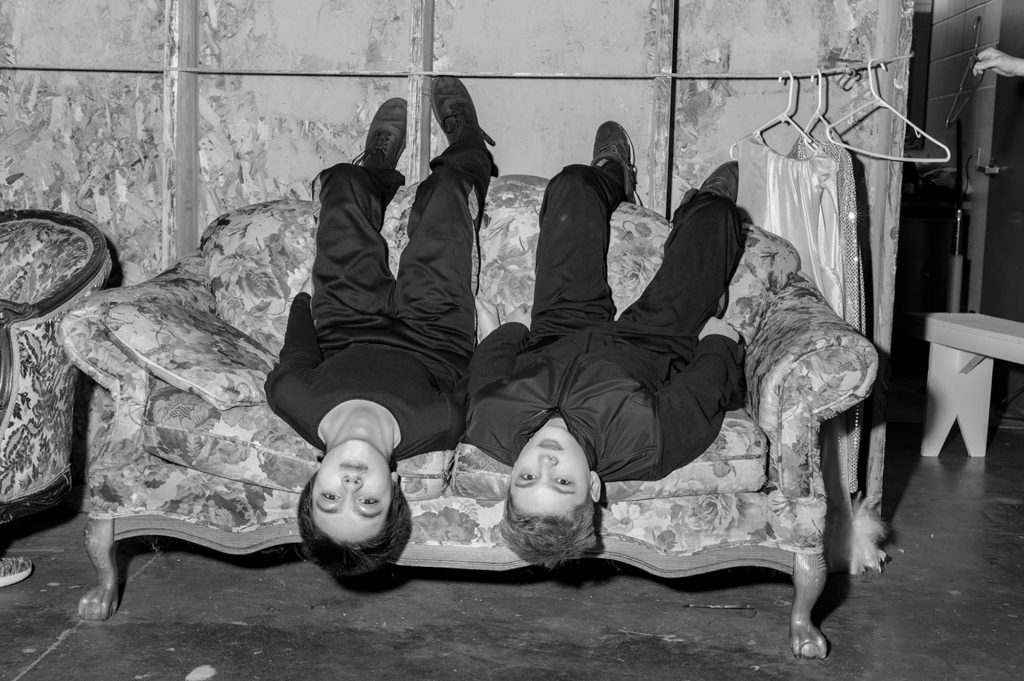 Two boys on a sofa, upside down