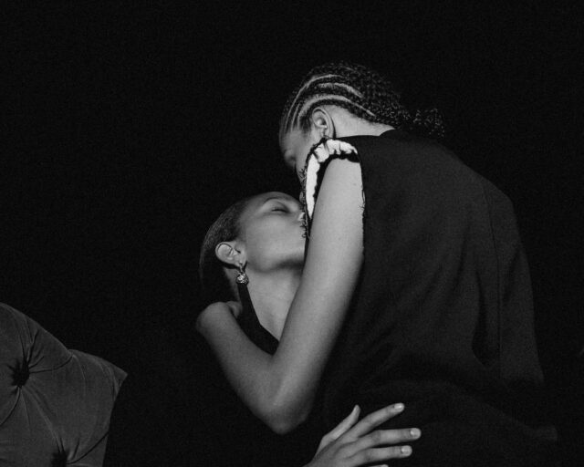 black and white photograph of two black women kissing