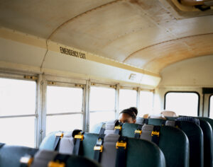 A young woman in a school bus.