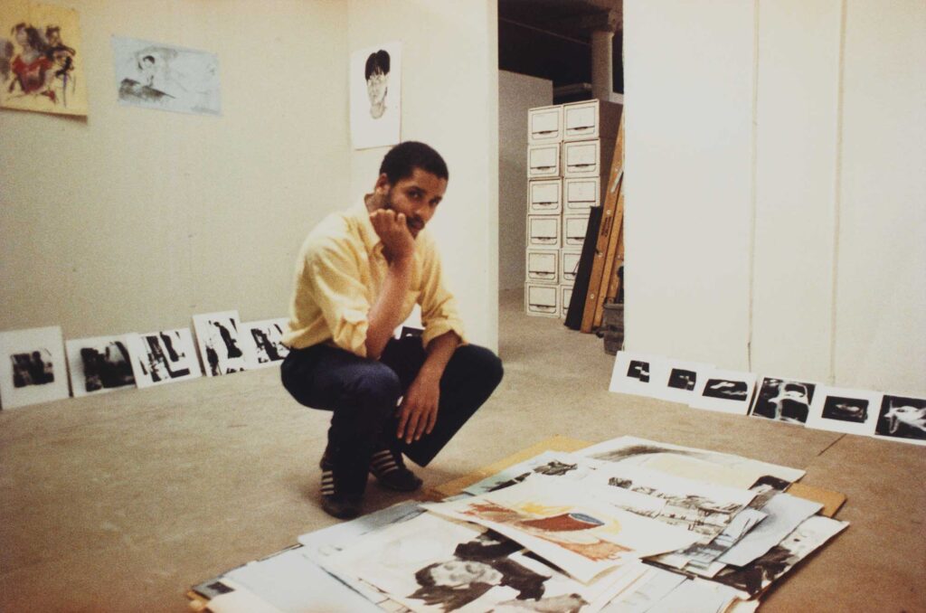 Color photograph of a Black male artist in his studio