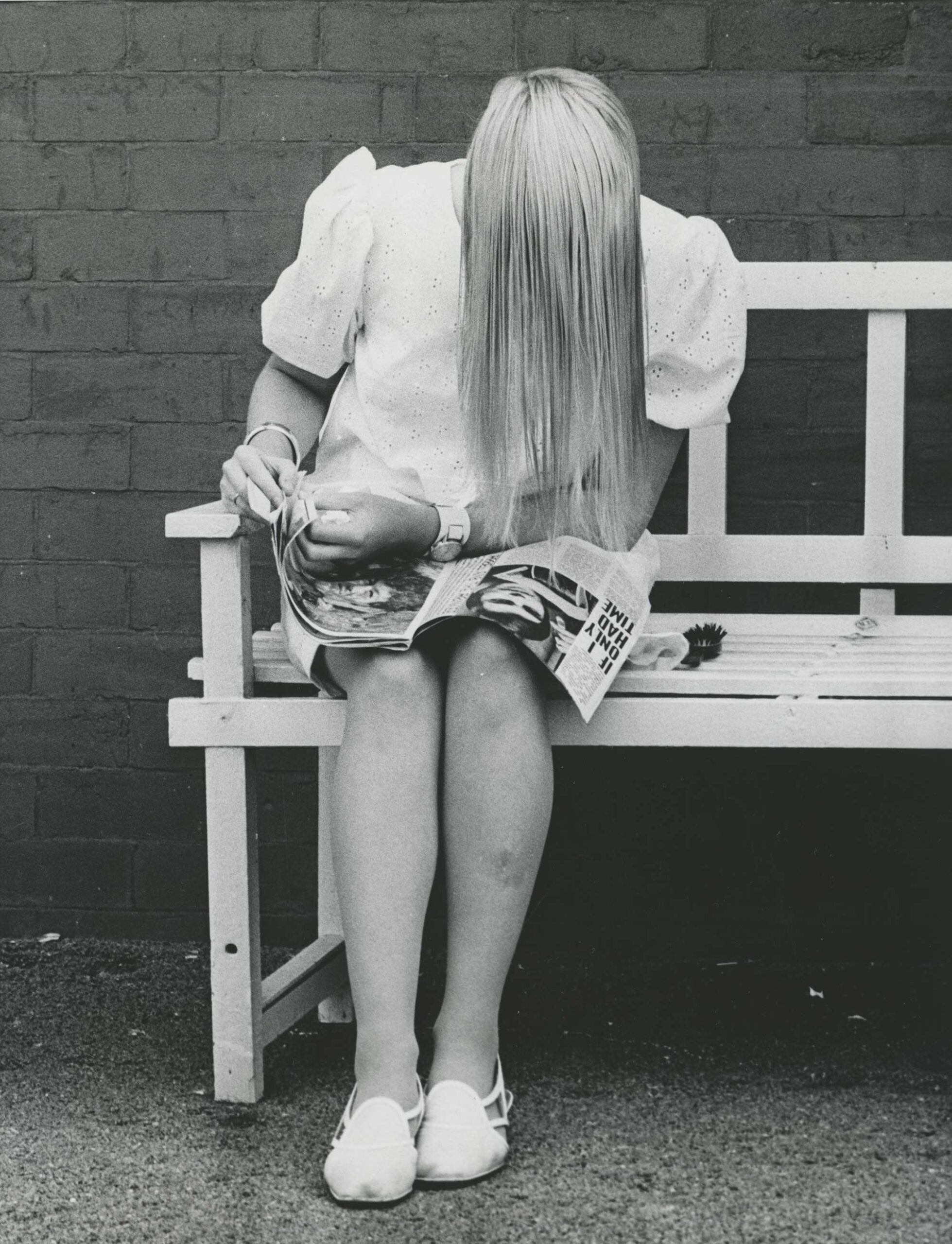 Black and white photograph of a blond woman reading