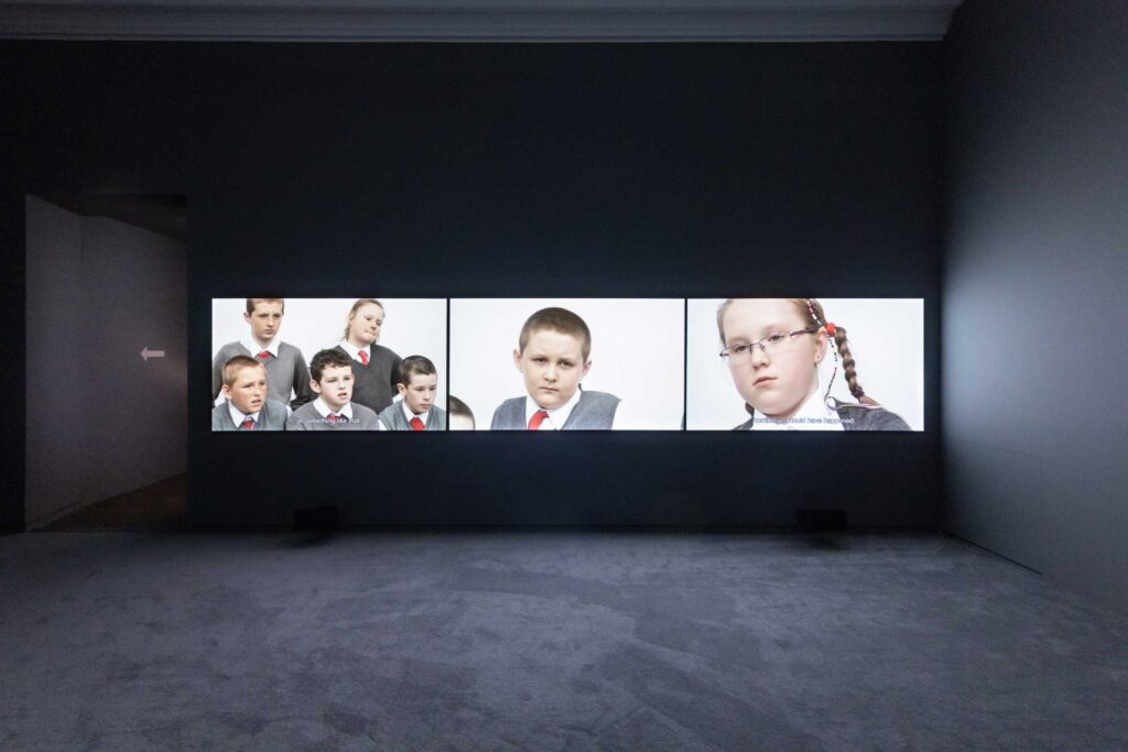 Installation view of three-screen video by Rineke Dijkstra