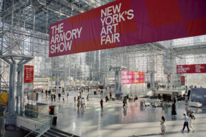 A large event space with glass windows and a banner that says 