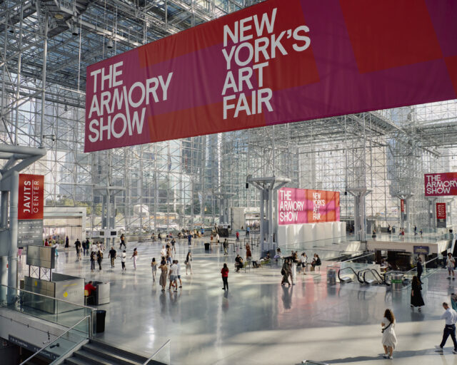 A large event space with glass windows and a banner that says 