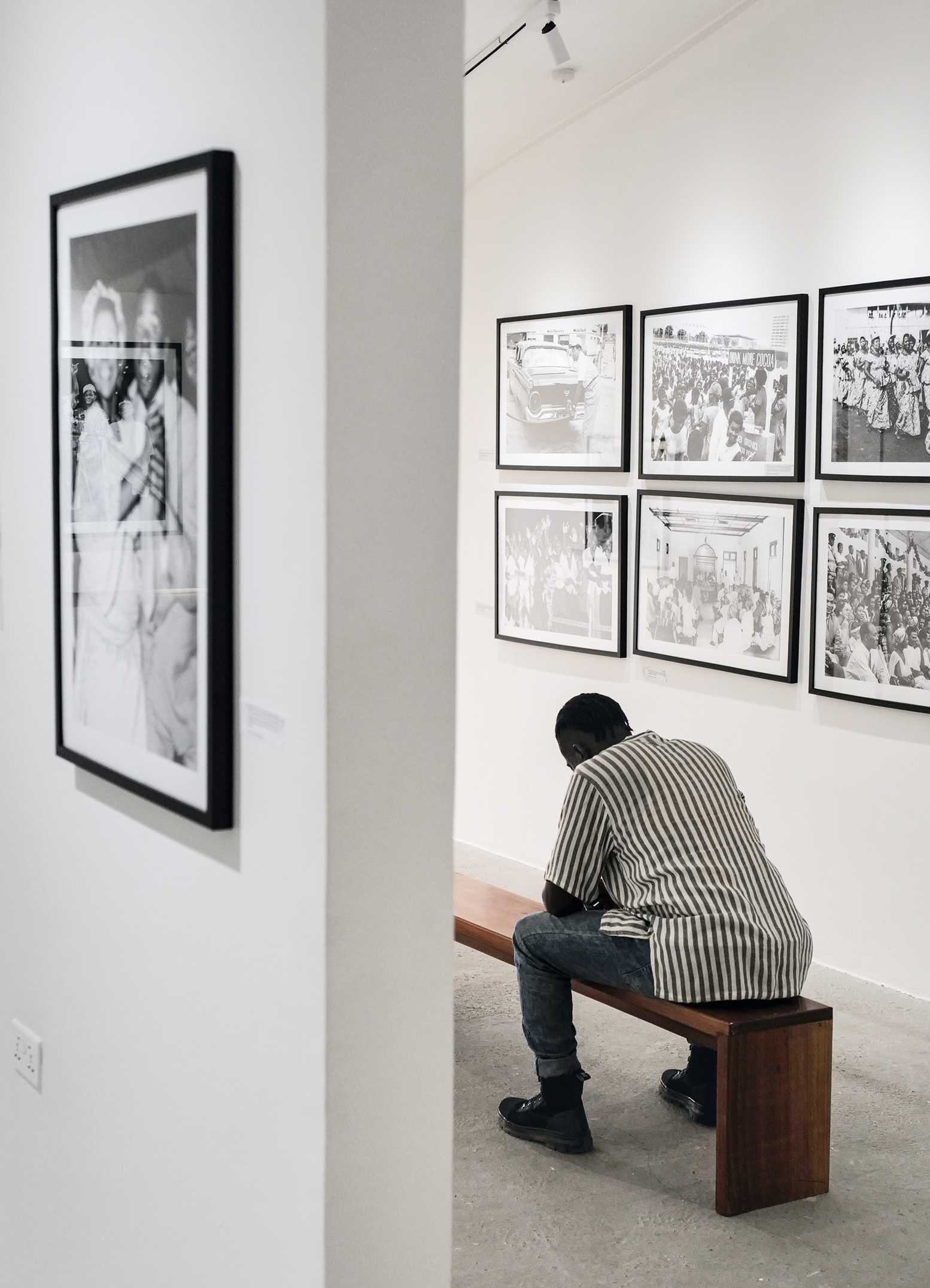 A visitor sits inside the photo gallery section of the Dikan Centre, a library dedicated to photography, initiated by Ghanaian photographer, Paul Ninson, in Accra, Ghana. April 11, 2023. Photo: Francis Kokoroko
