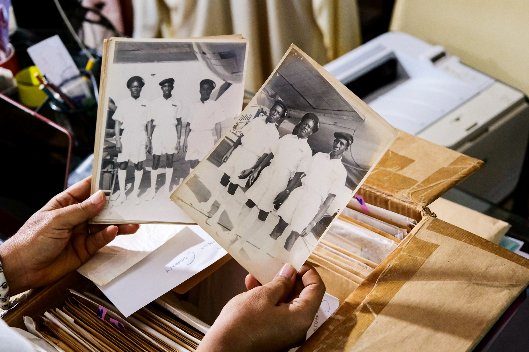 Kate Aku Tamakloe, 57, photo archivist and curator, sorts the photo archives of the family owned photography studio, Deo Gratias, at her home in Accra, Ghana August 18, 2022. Photo: Francis Kokoroko