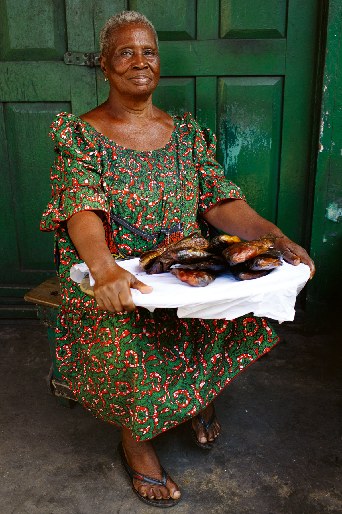 Winnifred Aku Tetteh, 68, a smoked fish seller poses for a photograph in Makola Market