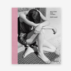 A book cover with a black and white photo of an individual sitting on the ground, forehead to knee, and arms crossed.
