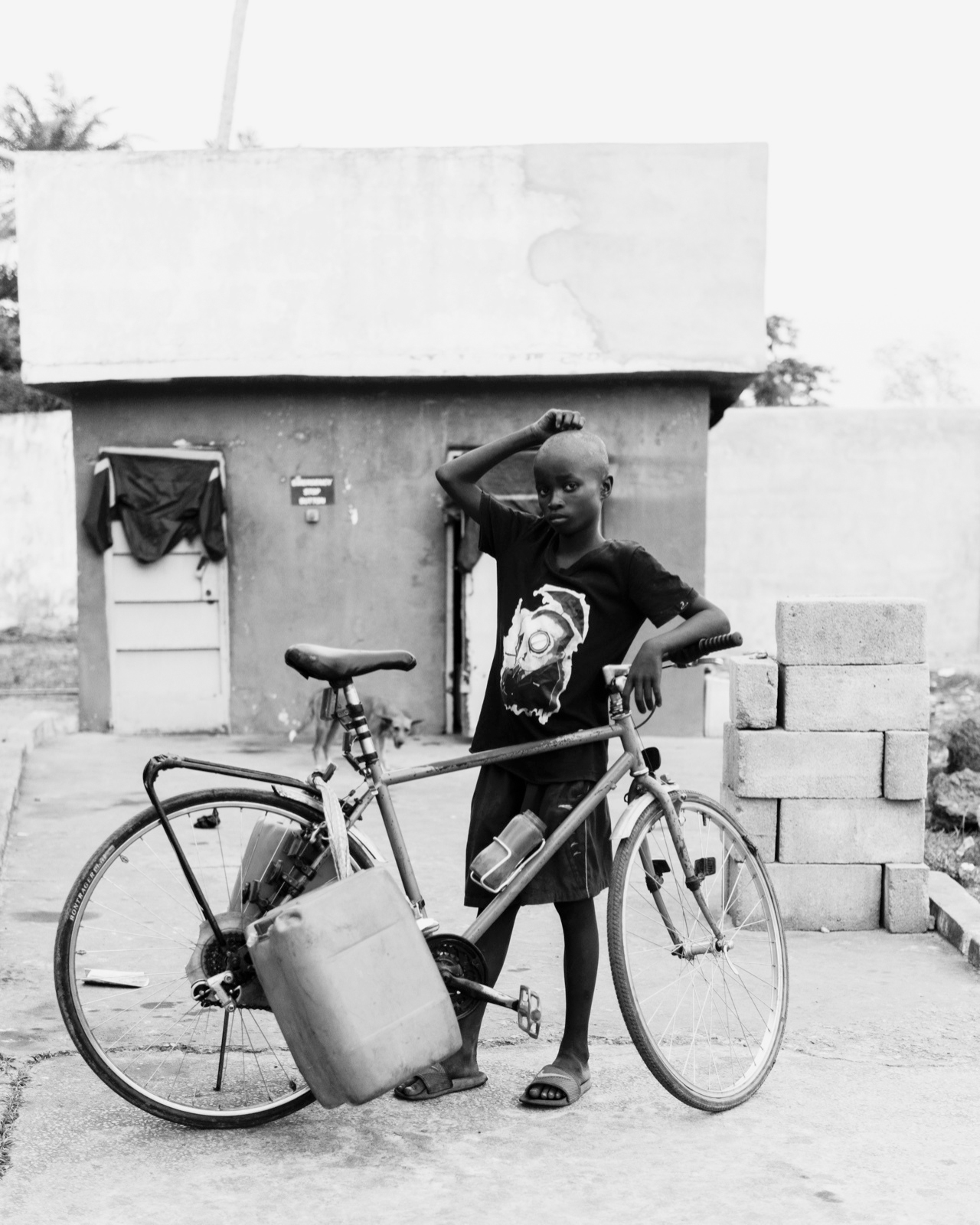 Abdul Hamid Kanu Jr., A boy stands by a bicycle, Lunsar, Northern Province, 2023