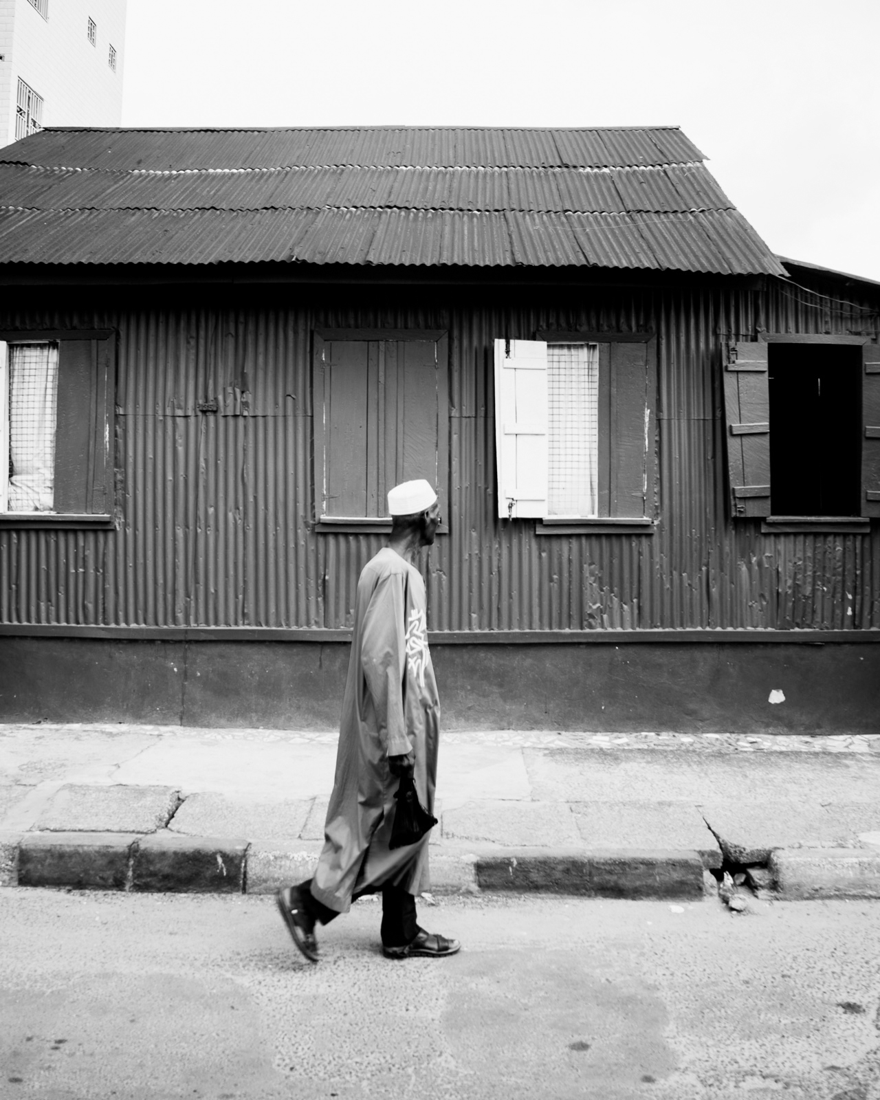 Abdul Hamid Kanu Jr., A man looking at a zinc house, Freetown, 2022