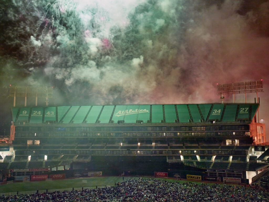 Fireworks exploding over the Oakland Coliseum at nigh.