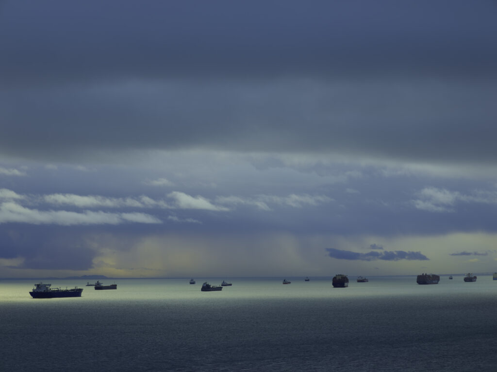Aperture_Misrach_Cargo_074 Cargo ships out on the ocean.