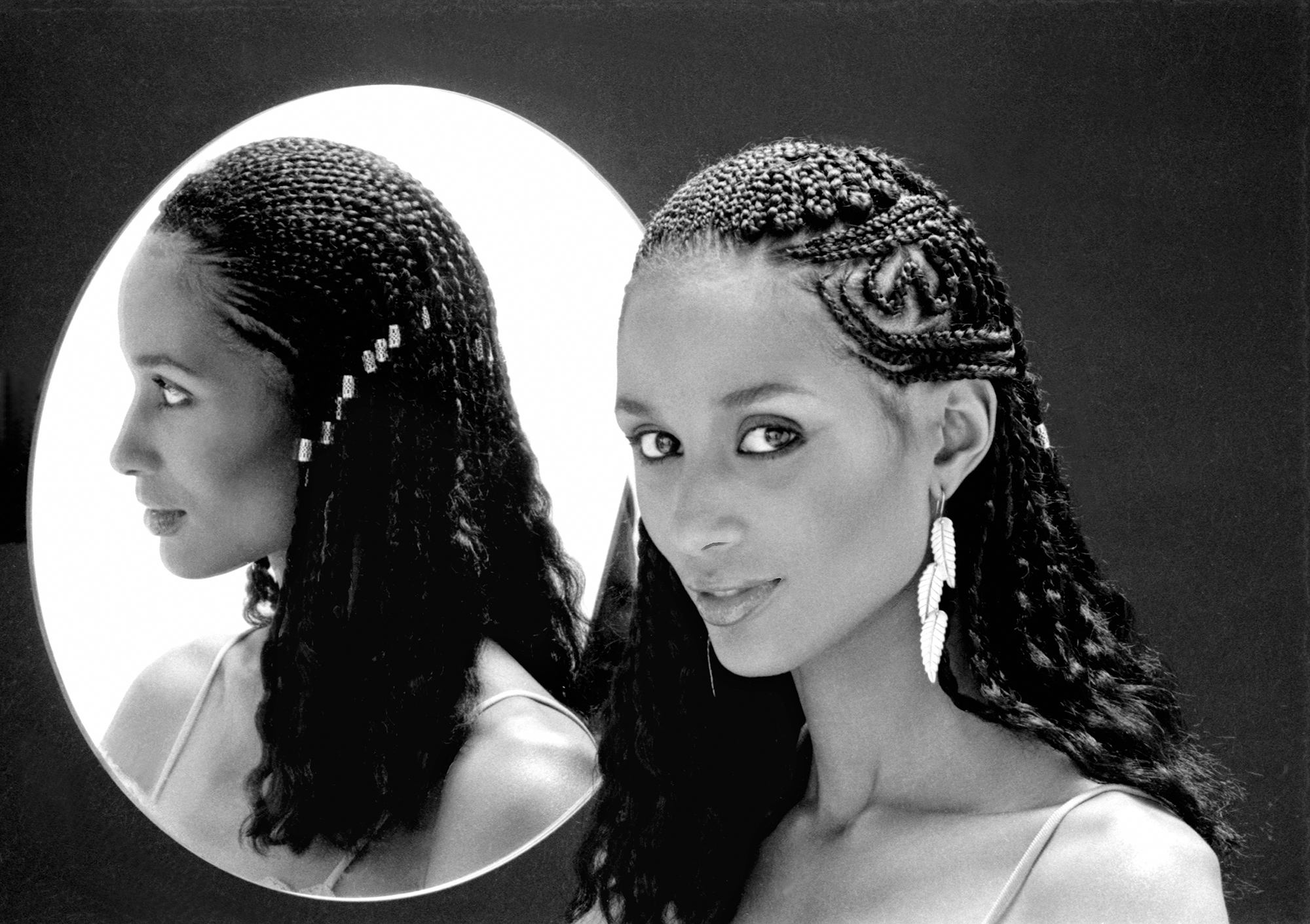 Portrait of American fashion model and actress Beverly Johnson, with braided hair, as she poses beside a mirror, New York, 1970s. (Photo by Anthony Barboza/Getty Images)