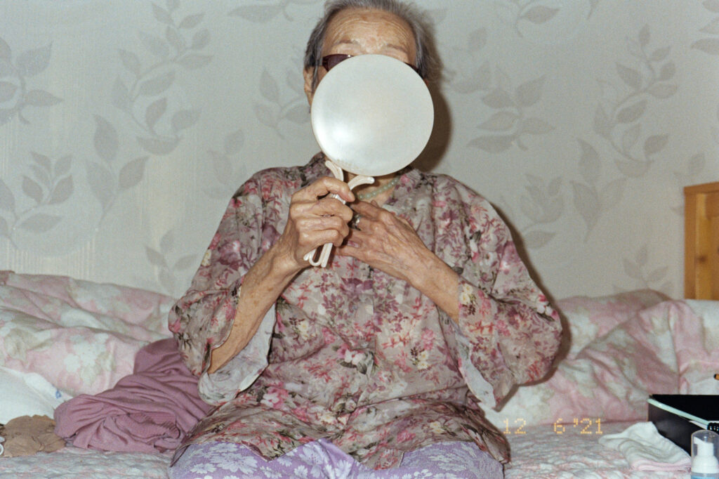 Chorong An, from the series K-Fragments, 2020–24 Courtesy the artist An older person looks in a mirror