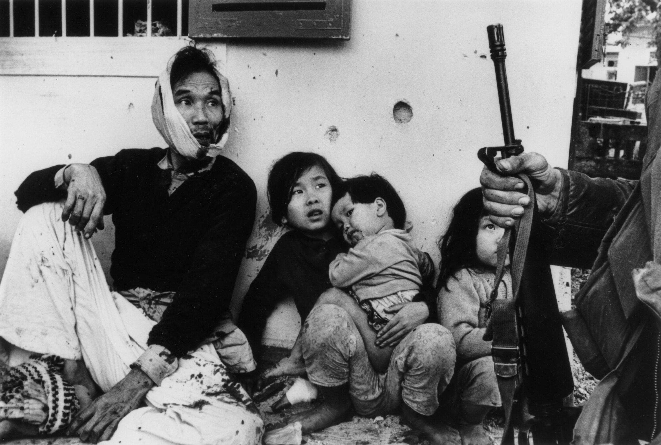 Family sit shocked and wounded after US marines dropped handgrenades into their shelter, Hué, Vietnam 1968