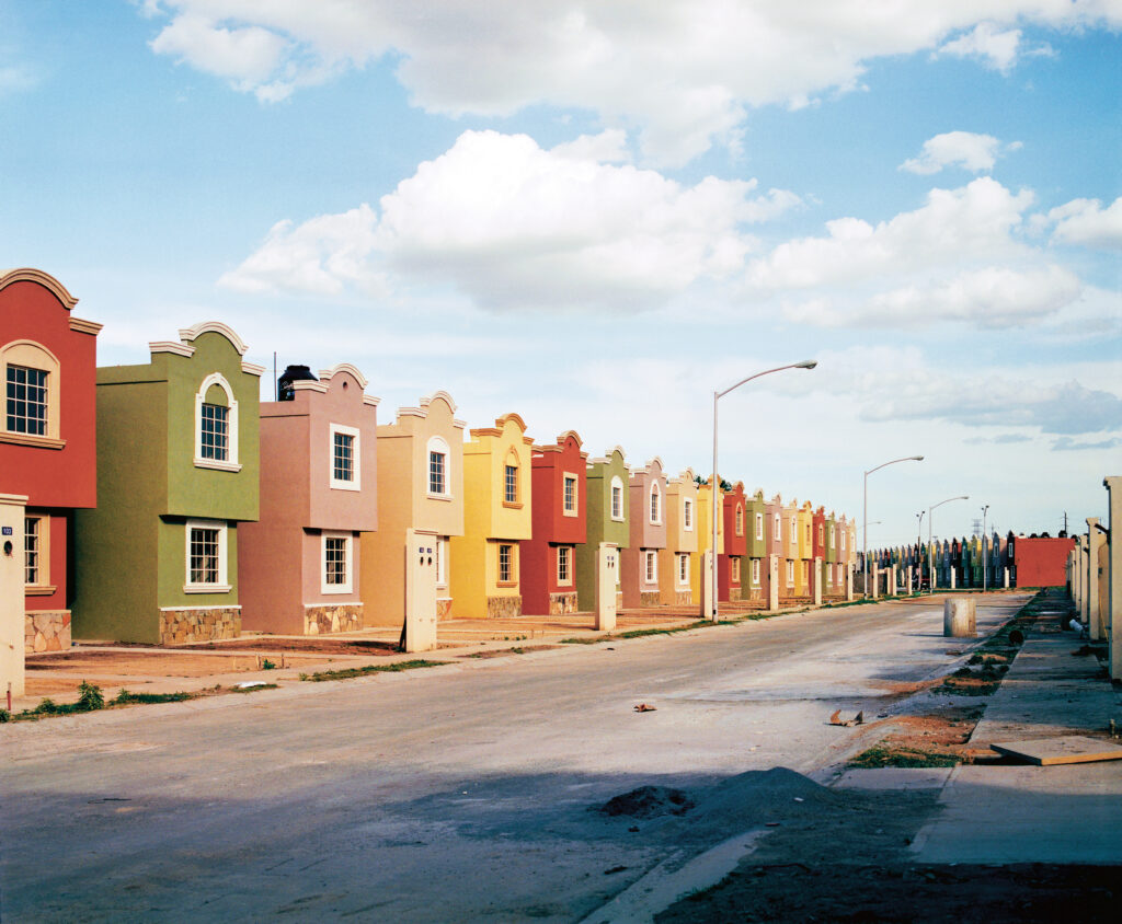 A street of identical colorful homes.