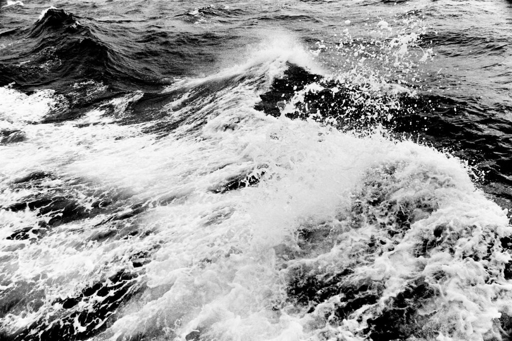 A black and white photograph of ocean waves