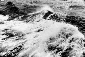 A black and white photograph of ocean waves