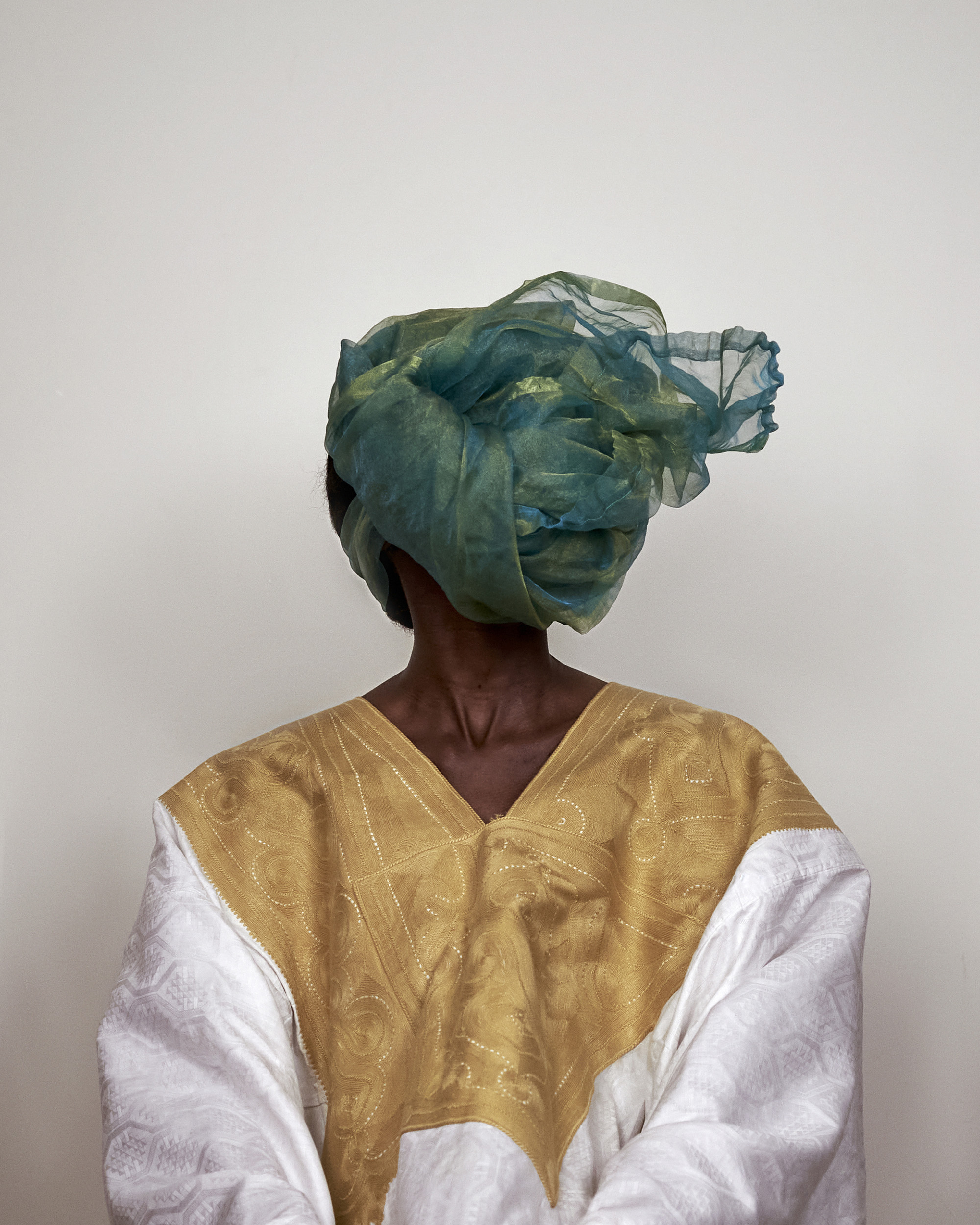 Souleymane Bachir Diaw, <em>Worn White Grand-Bubu With Golden Embroidery and Green Headscarf, Grey Area</em>, 2021, from the series <em>Sutura</em>, 2021–ongoing<br>Courtesy the artist”>
		</div>
		<div class=